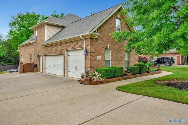 view of home's exterior featuring driveway, a shingled roof, an attached garage, and brick siding