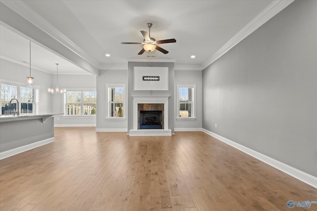 unfurnished living room featuring light wood-style floors, baseboards, and a tile fireplace