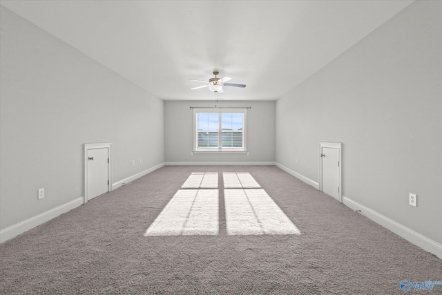 carpeted empty room with ceiling fan and baseboards