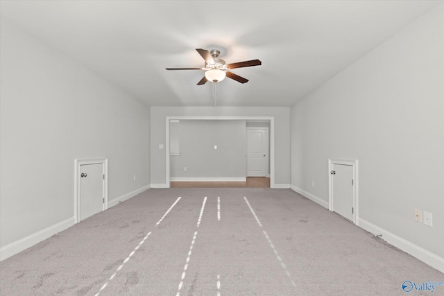 unfurnished living room with a ceiling fan, carpet, and baseboards