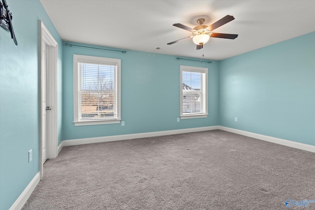 empty room featuring ceiling fan, carpet, and baseboards