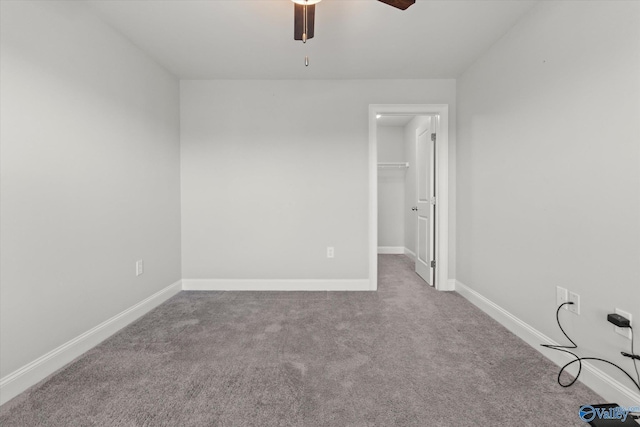 unfurnished room featuring carpet, ceiling fan, and baseboards