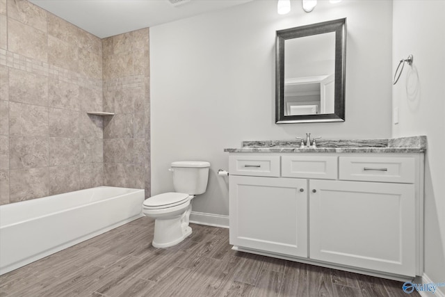 full bathroom with toilet, baseboards, wood finished floors, and vanity