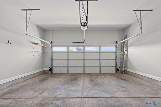 garage featuring a garage door opener and baseboards