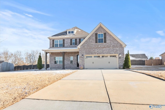 view of front of property featuring a garage, concrete driveway, brick siding, and fence