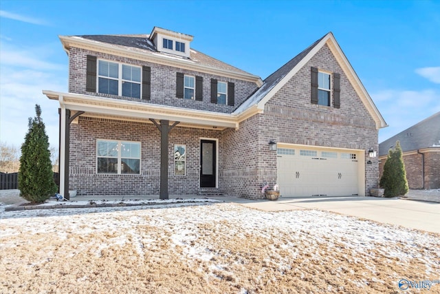 view of front of house with covered porch, driveway, brick siding, and an attached garage