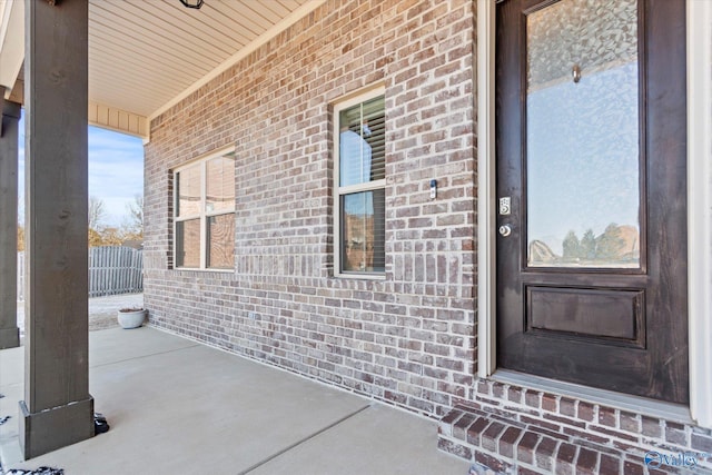 doorway to property with brick siding