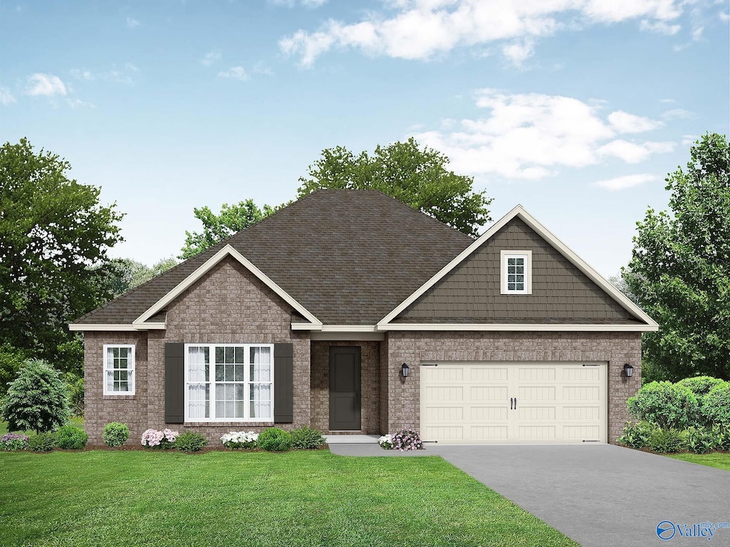 craftsman-style house featuring a garage and a front lawn