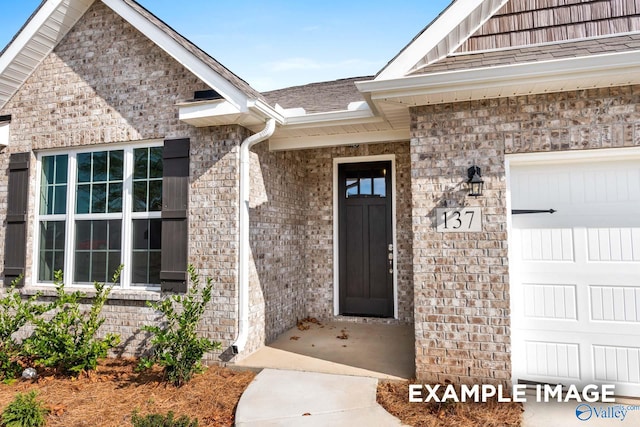 doorway to property with a garage