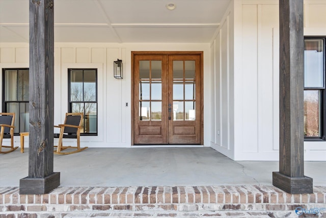 doorway to property featuring french doors and board and batten siding