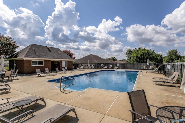 pool with fence and a patio area