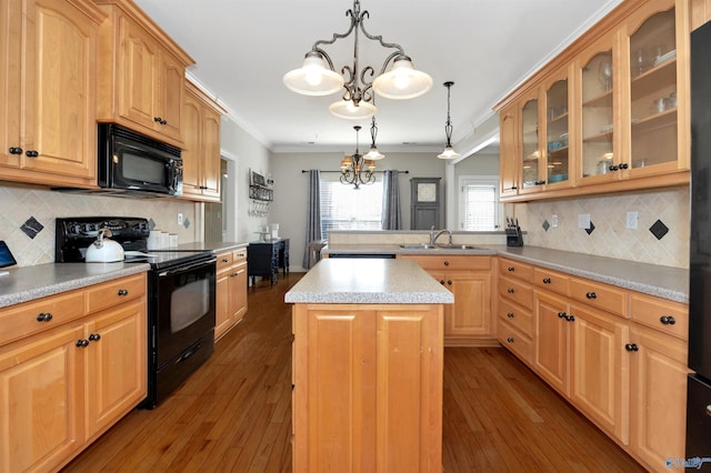 kitchen with light countertops, crown molding, a chandelier, a sink, and black appliances