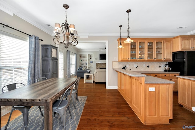 kitchen featuring dark wood finished floors, glass insert cabinets, a peninsula, and freestanding refrigerator