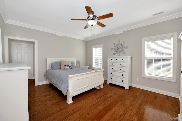 bedroom with ornamental molding and wood finished floors