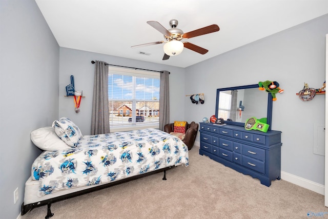 bedroom featuring baseboards, carpet floors, visible vents, and a ceiling fan