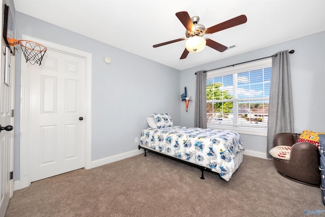 carpeted bedroom featuring baseboards, visible vents, and ceiling fan