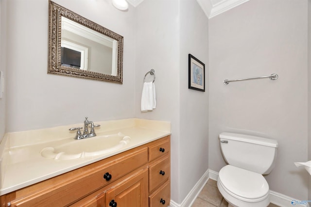 half bath with vanity, crown molding, toilet, baseboards, and tile patterned floors