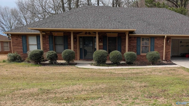 ranch-style house with brick siding, a front lawn, and a shingled roof