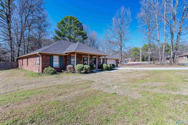 single story home featuring a front lawn, fence, roof with shingles, an attached garage, and brick siding