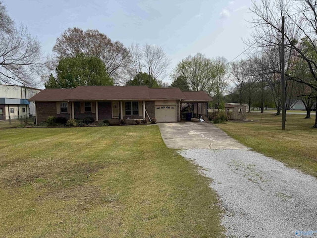 view of front of property with driveway, brick siding, a garage, and a front lawn