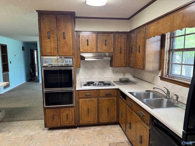 kitchen featuring dishwasher, double wall oven, stainless steel electric cooktop, under cabinet range hood, and a sink