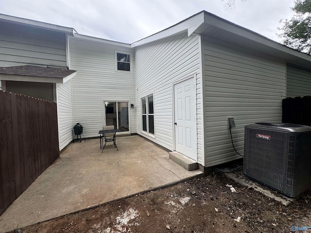 rear view of house with a patio area and central air condition unit