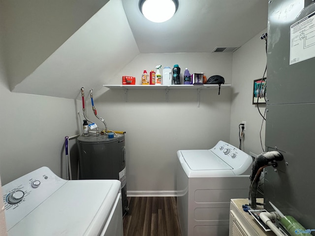 laundry room with dark hardwood / wood-style flooring, water heater, and washer and clothes dryer