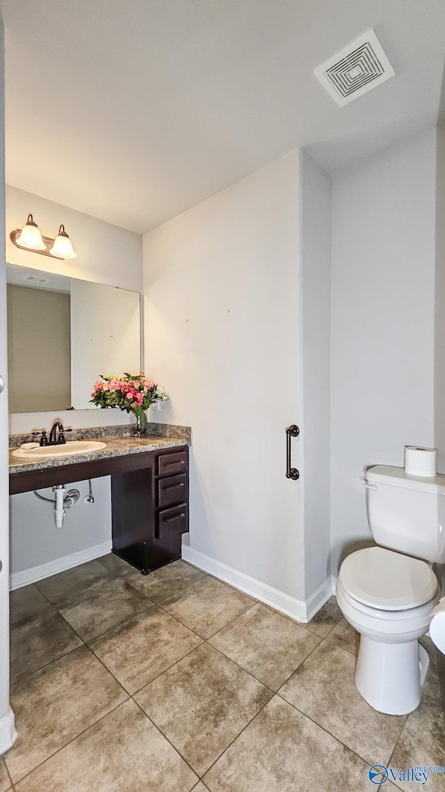 half bath with vanity, toilet, tile patterned floors, baseboards, and visible vents