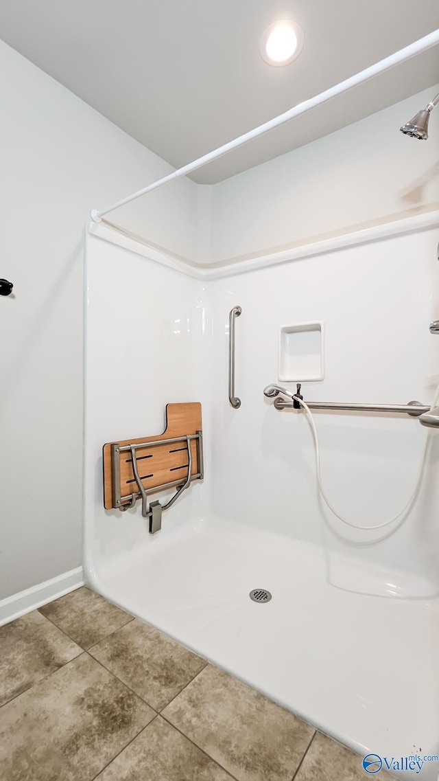 full bath with tile patterned floors, baseboards, and a shower