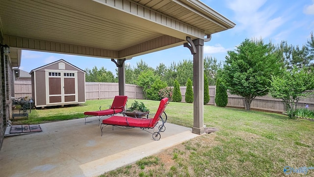 view of patio / terrace with an outdoor structure, a shed, and a fenced backyard