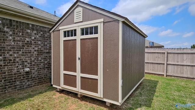 view of shed with fence