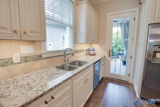 kitchen with stainless steel appliances, sink, and white cabinets