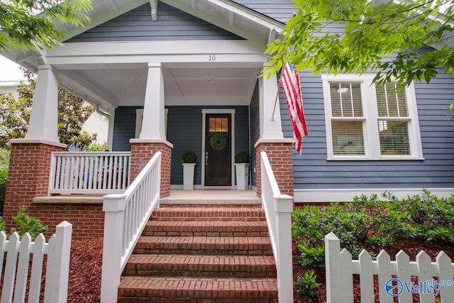 entrance to property featuring covered porch