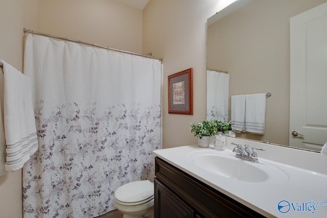 bathroom featuring vanity and toilet