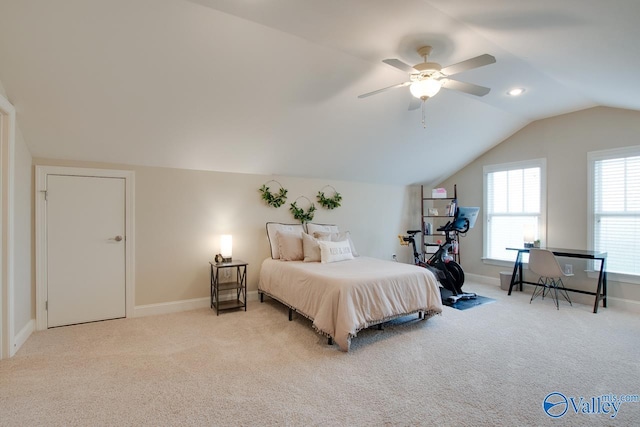 carpeted bedroom with ceiling fan and vaulted ceiling