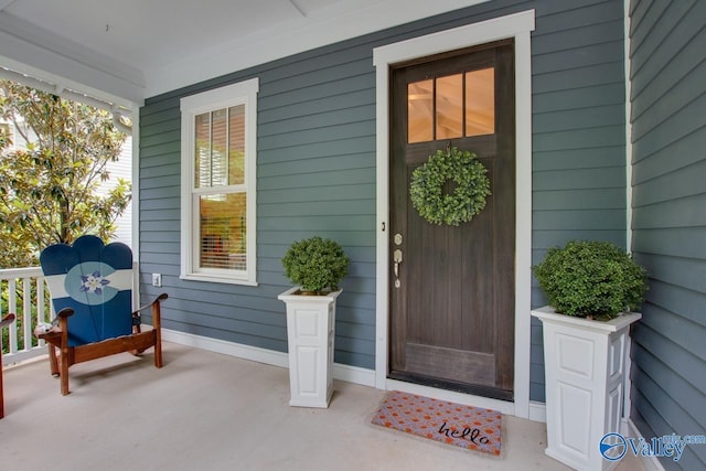 view of exterior entry with a porch