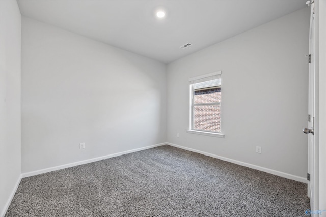 spare room featuring visible vents, baseboards, and carpet floors