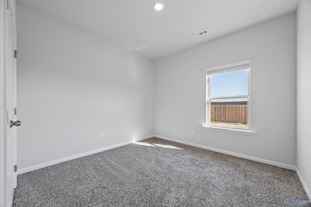 carpeted empty room with baseboards and visible vents