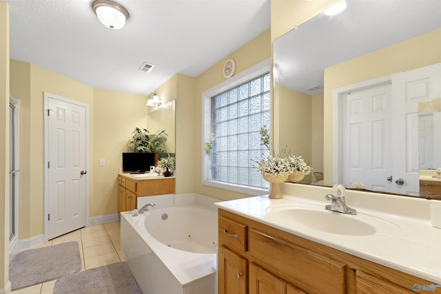 663 Gooch Ln, Madison, AL 35758 - full bathroom with tile patterned flooring, a tub with jets, a shower stall, two vanities, and baseboards