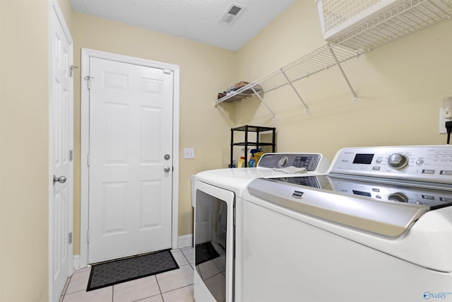 663 Gooch Ln, Madison, AL 35758 - clothes washing area with washer and clothes dryer, light tile patterned floors, and baseboards