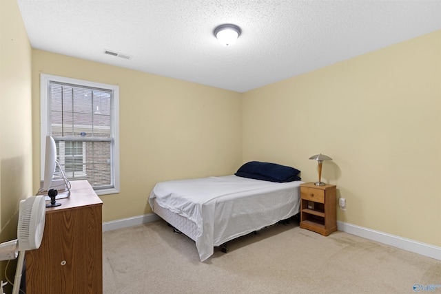 663 Gooch Ln, Madison, AL 35758 - bedroom with baseboards, light colored carpet, and a textured ceiling