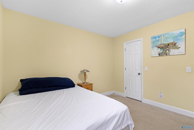 663 Gooch Ln, Madison, AL 35758 - bedroom featuring light carpet, baseboards, and a textured ceiling