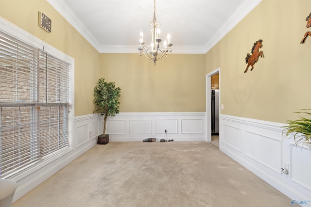 663 Gooch Ln, Madison, AL 35758 - unfurnished dining area featuring a chandelier, crown molding, carpet, a wainscoted wall, and a decorative wall