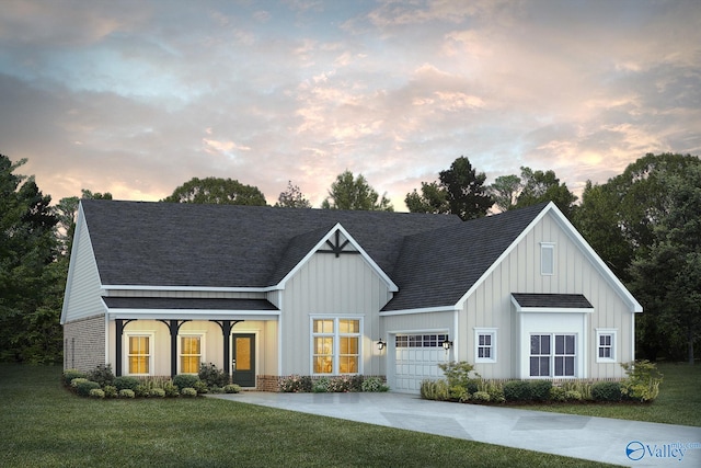 view of front of property featuring a garage and a lawn