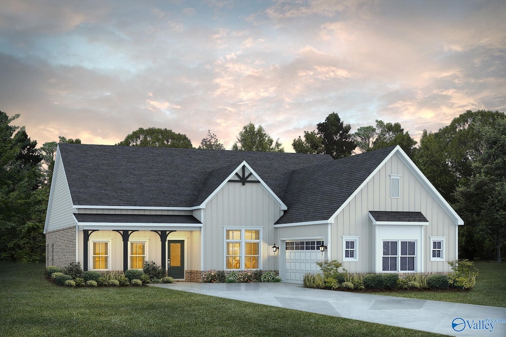 view of front of home featuring a garage and a lawn