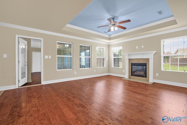164 Moore Farm Cir NW, Huntsville, AL 35806 - unfurnished living room with crown molding, a raised ceiling, wood finished floors, and visible vents