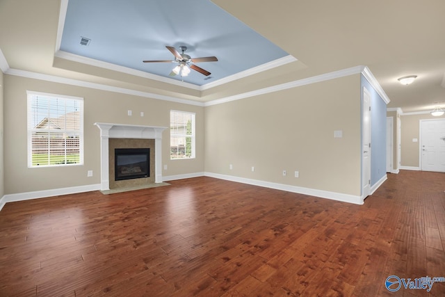 164 Moore Farm Cir NW, Huntsville, AL 35806 - unfurnished living room with dark wood-style flooring, a ceiling fan, visible vents, and a raised ceiling