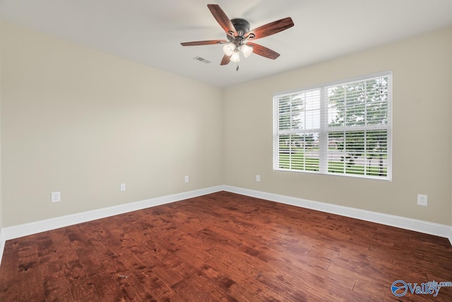 164 Moore Farm Cir NW, Huntsville, AL 35806 - spare room featuring baseboards, a ceiling fan, dark wood-style floors, and visible vents