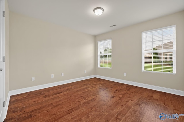 164 Moore Farm Cir NW, Huntsville, AL 35806 - empty room with baseboards, dark wood finished floors, and visible vents