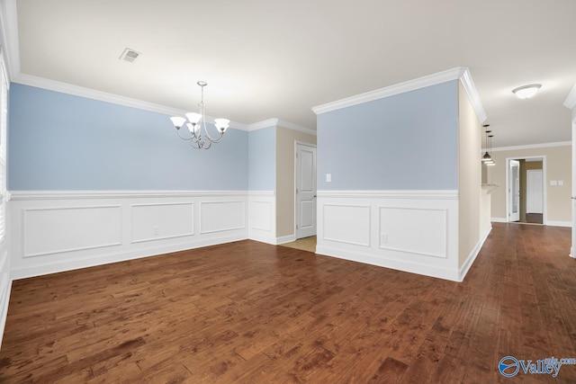164 Moore Farm Cir NW, Huntsville, AL 35806 - unfurnished room with a wainscoted wall, wood finished floors, a chandelier, and visible vents